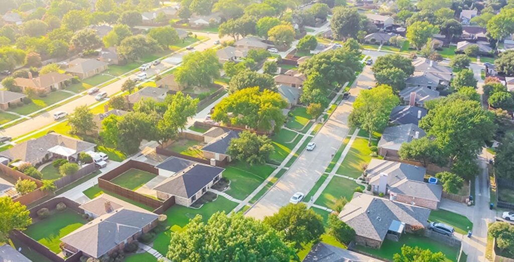 An aerial view of a neighborhood containing single family homes