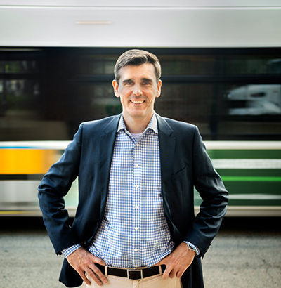 an image of Chris Dempsey with an MBTA bus behind him