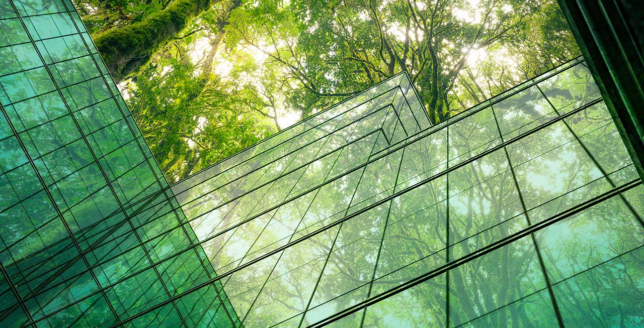 an image showing a glass building with trees in the background