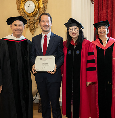 an alum of the AMDP smiling with his certificate