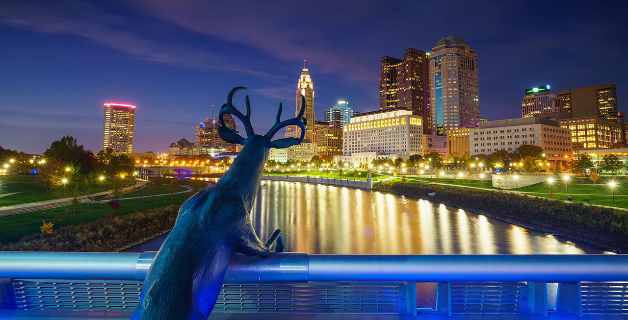 an image of downtown Columbus, Ohio, with a Scioto deer in the foreground