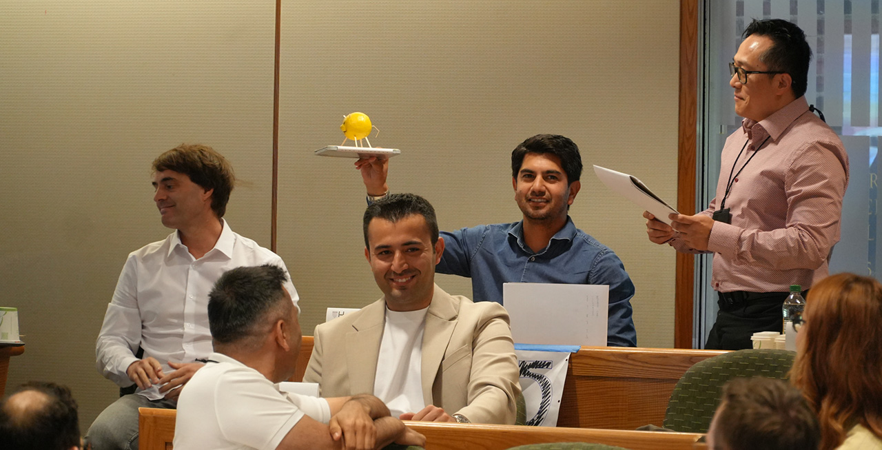 an image of people learning happily in an AMDP elective program